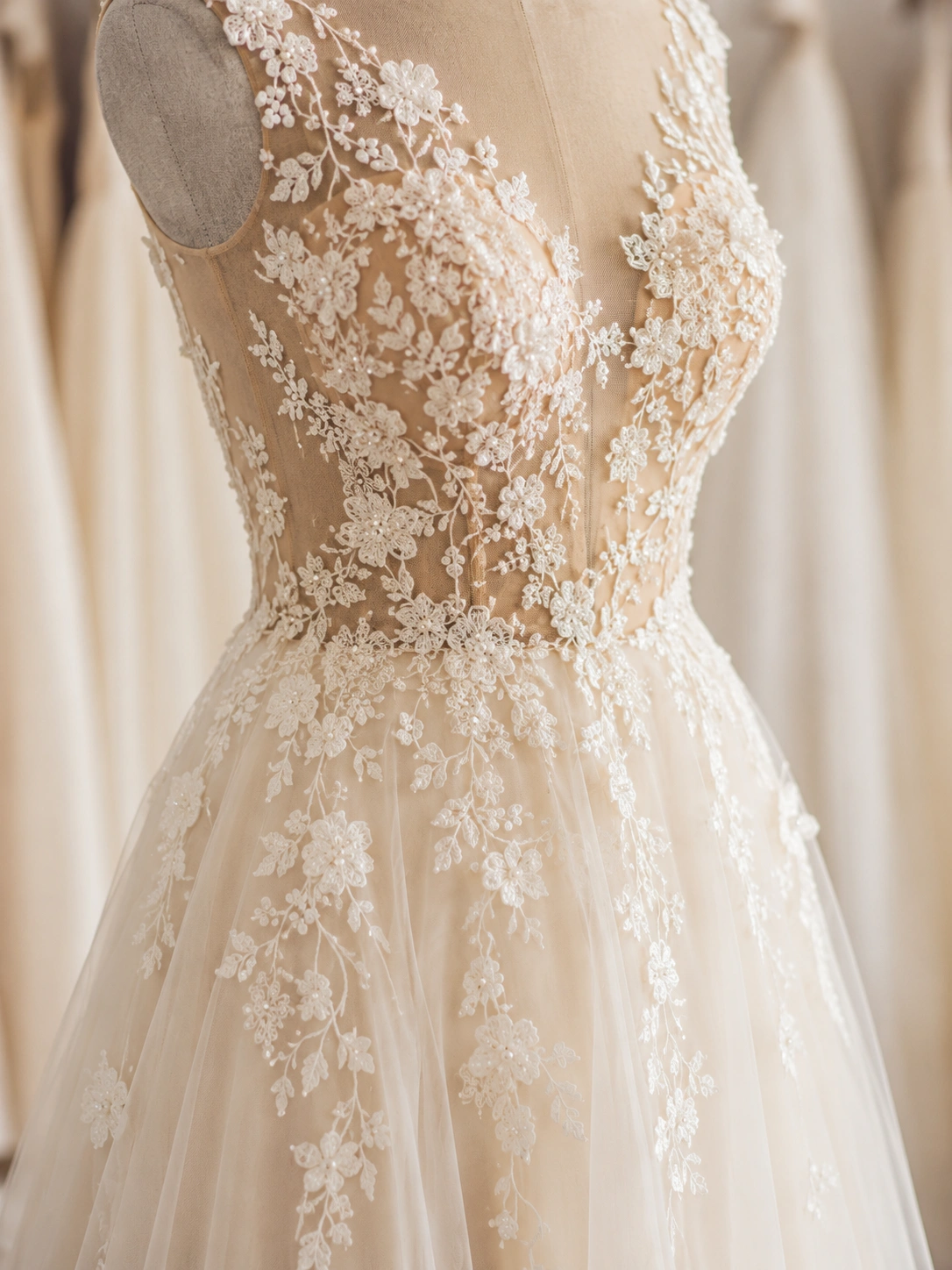 Detaliu de rochie de mireasă cu dantelă florală și aplicații delicate